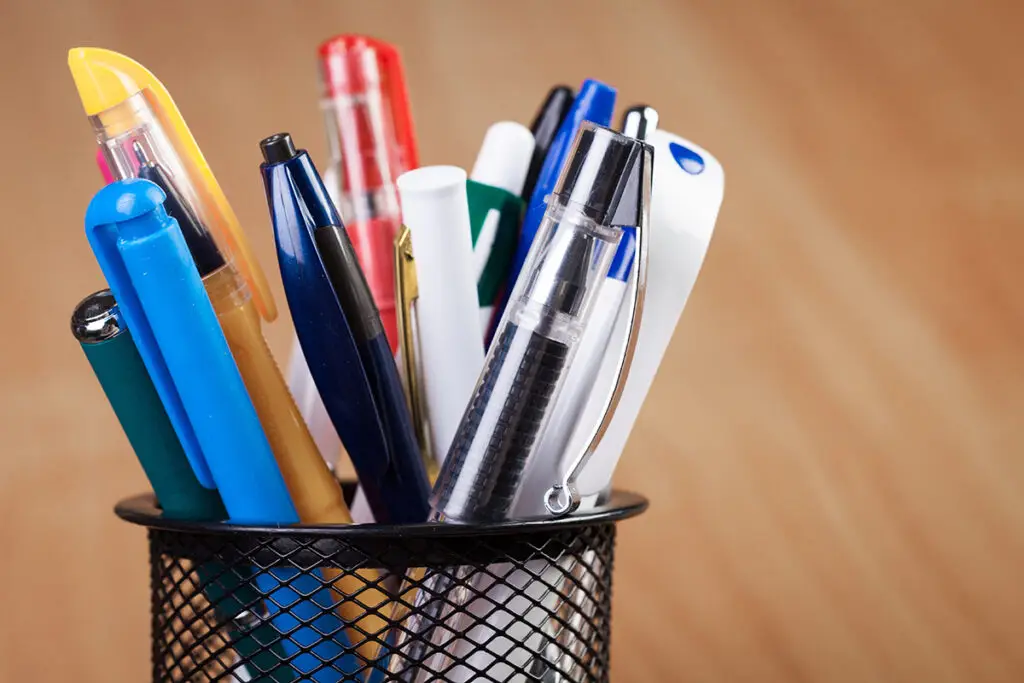 Sammlung verschiedener Kugelschreiber und Stifte als klassische Werbeartikel in einem Stiftehalter.